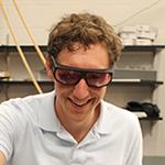 Jason Bartell in an optics laboratory