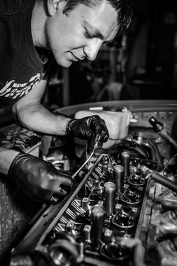 Ivan Temnykh works on a car engine.