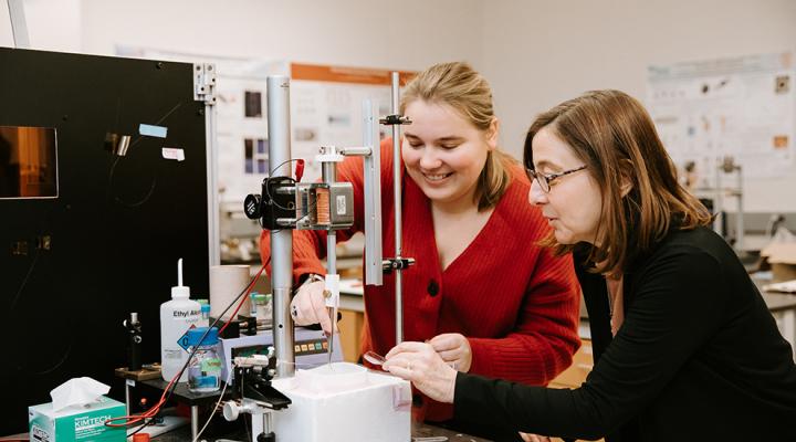 Kara Zielinski (left) and Lois Pollack (right) align a gas dynamic virtual nozzle stream to a target.