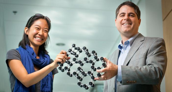 Graduate student Pinshane Huang and Professor David Muller with a model that depicts the atomic structure of glass. They were the first to directly image the world's thinnest sheet of glass.