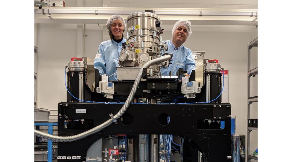 Lena and David in the Thermo Fisher factory clean room with the (in progress) build of Cornell's Spectra 300 X-CFEG "Kraken" STEM