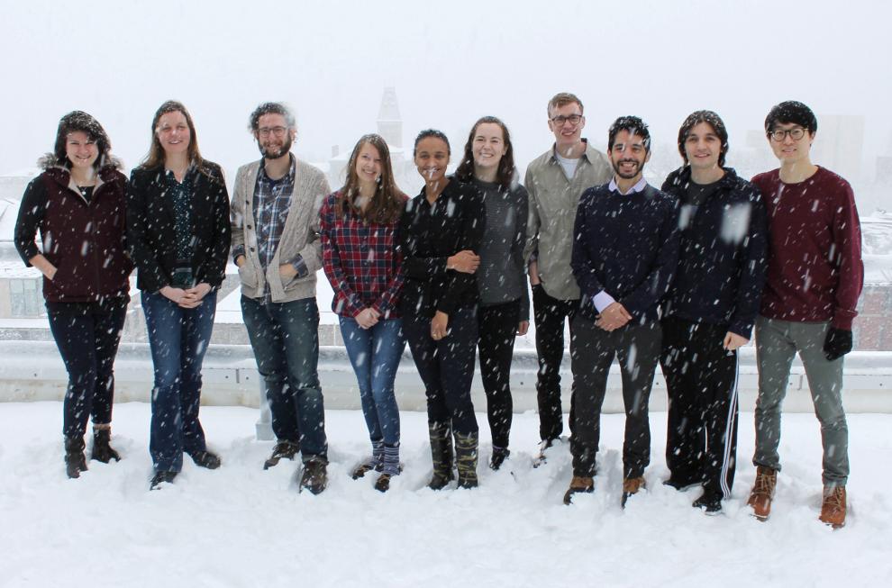 Lena and 8 students standing in snow on the roof of the Physical Sciences Building